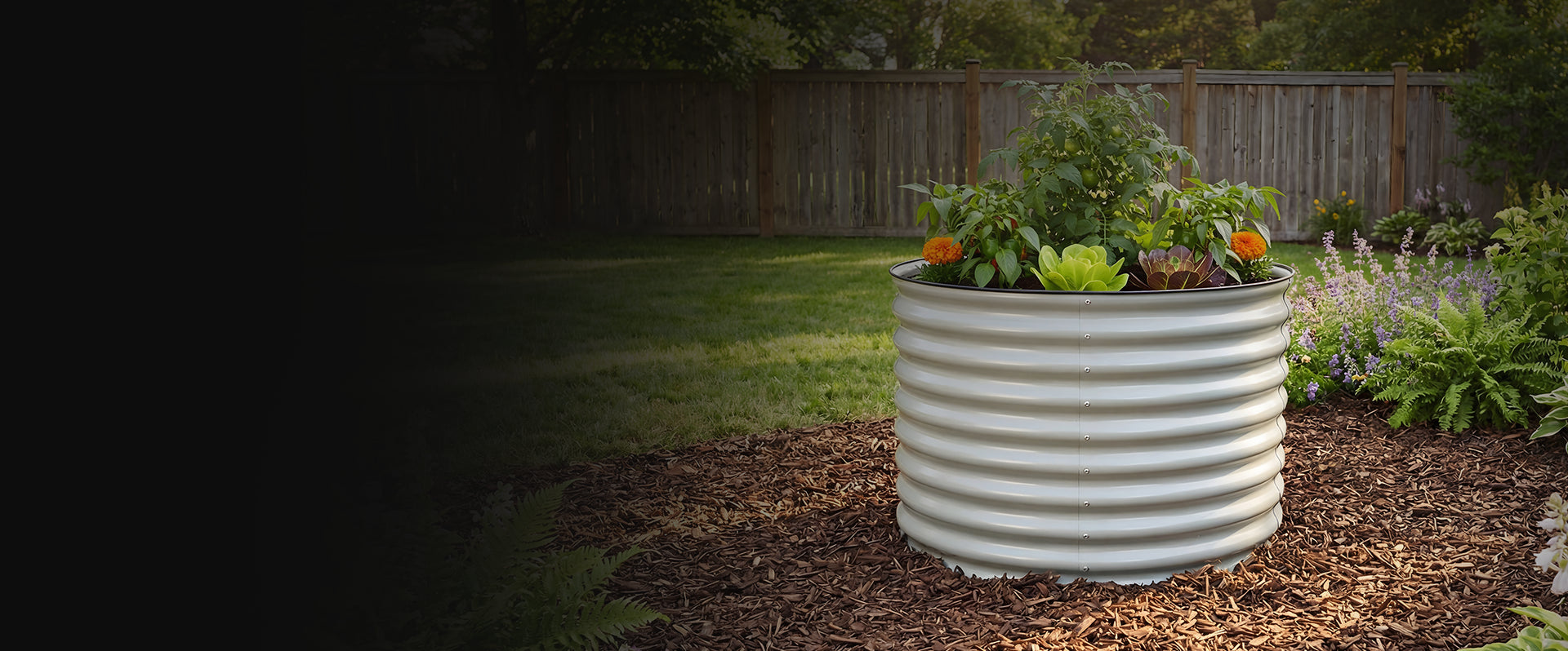 Large white corrugated planter with plants in a garden setting